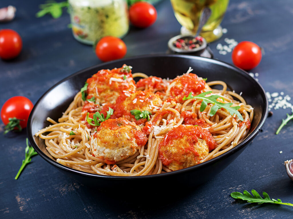 italian-pasta-spaghetti-with-meatballs-parmesan-cheese-black-plate-dark-rustic-wood-background-dinner-slow-food-concept